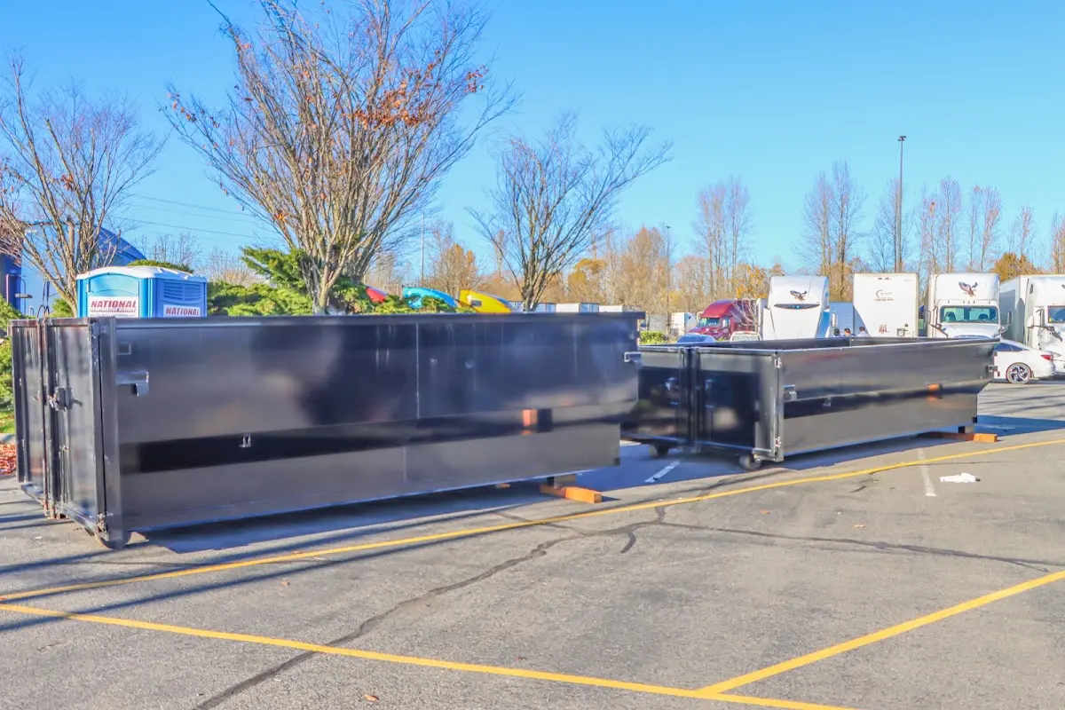 Professional dumpster rental service with roll-off container on residential driveway in Northchase